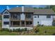 A wide-angle shot of the rear exterior elevation with tiered porches and stone steps at 23 Sunset Se Rdg, Cartersville, GA 30121