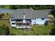 Aerial view of the rear of the home showing tiered porches and the expansive backyard at 23 Sunset Se Rdg, Cartersville, GA 30121