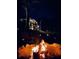 Cozy nighttime view of a firepit ablaze, enhancing the outdoor ambiance of the home at 23 Sunset Se Rdg, Cartersville, GA 30121