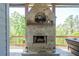 Outdoor stone fireplace with mounted decorative artwork on covered deck at 23 Sunset Se Rdg, Cartersville, GA 30121