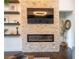 Modern fireplace with stone accent wall, mounted TV, floating shelves, and contemporary design at 23 Sunset Se Rdg, Cartersville, GA 30121