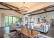 Bright living room features hardwood floors, modern furnishings, wood beam ceilings, and a statement chandelier at 23 Sunset Se Rdg, Cartersville, GA 30121