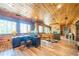 Cozy living room with wood walls, a foosball table, and a stone fireplace at 23 Sunset Se Rdg, Cartersville, GA 30121