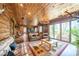 Spacious living room with wood walls, antler chandelier, and sliding glass doors to the deck at 23 Sunset Se Rdg, Cartersville, GA 30121