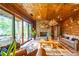 Relax in this living room with wood walls, a stone fireplace, and deck access at 23 Sunset Se Rdg, Cartersville, GA 30121