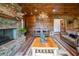 Living room featuring stone fireplace, antler chandelier, log walls, and comfortable seating at 23 Sunset Se Rdg, Cartersville, GA 30121