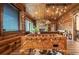 Inviting living room features wood walls, natural light, a stone fireplace, and foosball table at 23 Sunset Se Rdg, Cartersville, GA 30121