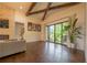 Open-concept living area with hardwood floors, stone fireplace, and expansive glass doors to an outdoor space at 23 Sunset Se Rdg, Cartersville, GA 30121
