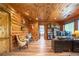 Home office with log walls, built-in bookshelves, desk, and bright windows at 23 Sunset Se Rdg, Cartersville, GA 30121