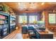Wood-paneled office featuring built-in bookshelves, a large desk, and bright windows at 23 Sunset Se Rdg, Cartersville, GA 30121