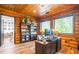 Wood-paneled office featuring built-in bookshelves, a large desk, and bright windows at 23 Sunset Se Rdg, Cartersville, GA 30121