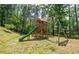 A wooden playset with slide and swing on a spacious, grassy lawn perfect for outdoor fun at 23 Sunset Se Rdg, Cartersville, GA 30121