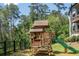 Wooden backyard playhouse with slide, nestled among the trees at 23 Sunset Se Rdg, Cartersville, GA 30121