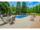 Community swimming pool surrounded by lounge chairs and umbrellas on a sunny day at 23 Sunset Se Rdg, Cartersville, GA 30121