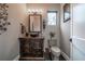 Rustic powder room with a unique vanity, vessel sink, decorative mirror, and tiled floor, creating a charming ambiance at 23 Sunset Se Rdg, Cartersville, GA 30121