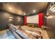 Relax in this theater room featuring tiered seating, a large screen, and dimmable wall sconces at 23 Sunset Se Rdg, Cartersville, GA 30121