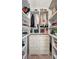 Walk-in closet with custom shelving and drawer unit providing ample storage space at 23 Sunset Se Rdg, Cartersville, GA 30121