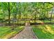 Expansive backyard with lush landscaping, bridge, and wooded views creates a peaceful oasis at 2511 Oak Ave, Tucker, GA 30084