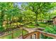 Brick home with expansive backyard featuring a stone path and wooden bridge at 2511 Oak Ave, Tucker, GA 30084