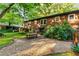Brick home with a patio, picnic table, gravel pathway, and lawn at 2511 Oak Ave, Tucker, GA 30084