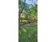 Expansive backyard with lush landscaping, bridge, and wooded views creates a peaceful oasis at 2511 Oak Ave, Tucker, GA 30084