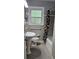 Bathroom featuring a pedestal sink, toilet, shower, and a window at 2511 Oak Ave, Tucker, GA 30084