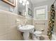 Bathroom featuring a pedestal sink, toilet, shower, and a window at 2511 Oak Ave, Tucker, GA 30084