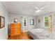 Bedroom features hardwood floors, a ceiling fan, and two windows for natural light at 2511 Oak Ave, Tucker, GA 30084