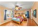 Bright bedroom features hardwood floors, a ceiling fan, and two windows for natural light at 2511 Oak Ave, Tucker, GA 30084
