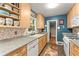 Functional kitchen featuring light wood cabinetry, mosaic backsplash, and efficient appliances at 2511 Oak Ave, Tucker, GA 30084
