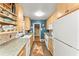 Galley kitchen with wood cabinets, mosaic backsplash, and colorful decor at 2511 Oak Ave, Tucker, GA 30084