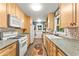 Galley kitchen with wood cabinets, mosaic backsplash, and colorful decor at 2511 Oak Ave, Tucker, GA 30084
