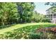 Expansive backyard with lush lawn, mature trees, and landscaped areas at 5199 Beech Forest Sw Dr, Lilburn, GA 30047