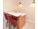Basement bar area featuring tile flooring, light wood cabinets, and a sink at 5199 Beech Forest Sw Dr, Lilburn, GA 30047