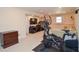 Basement area with a Peloton and a couch, great for relaxing or working out at 5199 Beech Forest Sw Dr, Lilburn, GA 30047