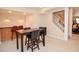 Finished basement with a bar area, table with chairs, and stairway at 5199 Beech Forest Sw Dr, Lilburn, GA 30047