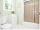 Bathroom featuring a toilet, built-in storage cabinet, and shower with sliding glass doors at 5199 Beech Forest Sw Dr, Lilburn, GA 30047