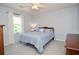 Comfortable bedroom with a large window, soft carpet, and ceiling fan at 5199 Beech Forest Sw Dr, Lilburn, GA 30047