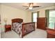 Comfortable bedroom featuring a ceiling fan, neutral carpeting and trim, and natural light at 5199 Beech Forest Sw Dr, Lilburn, GA 30047