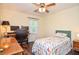 Neutral-toned bedroom has ceiling fan, a desk, and an office chair for work or study at 5199 Beech Forest Sw Dr, Lilburn, GA 30047