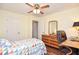 Bedroom features neutral carpeting, ceiling fan, wooden desk, and a leather office chair at 5199 Beech Forest Sw Dr, Lilburn, GA 30047