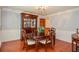 Traditional dining room featuring a wood table, decorative china cabinet, and hardwood floors at 5199 Beech Forest Sw Dr, Lilburn, GA 30047