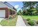 Charming brick home with manicured landscaping and a walkway leading to the front entrance at 5199 Beech Forest Sw Dr, Lilburn, GA 30047