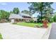 Beautiful brick home with attached garage, complemented by a large front lawn and mature trees at 5199 Beech Forest Sw Dr, Lilburn, GA 30047