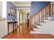 Inviting foyer with hardwood floors, staircase, and elegant table with decor at 5199 Beech Forest Sw Dr, Lilburn, GA 30047