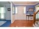 Elegant foyer features hardwood floors, staircase with wood and iron railing, and natural light at 5199 Beech Forest Sw Dr, Lilburn, GA 30047