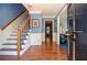 Bright foyer with hardwood floors, staircase, and blue accent walls at 5199 Beech Forest Sw Dr, Lilburn, GA 30047