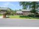 Traditional brick home with a manicured lawn, mature trees, and a circular driveway at 5199 Beech Forest Sw Dr, Lilburn, GA 30047