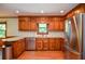 Updated kitchen featuring stainless steel appliances, white subway tile backsplash, and knotty wood cabinets at 5199 Beech Forest Sw Dr, Lilburn, GA 30047