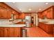 Spacious kitchen with stainless steel appliances, granite countertops, and knotty wood cabinets at 5199 Beech Forest Sw Dr, Lilburn, GA 30047
